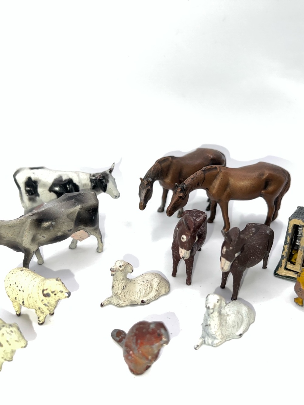 Collection of vintage miniature farm animal figurines, made of metal